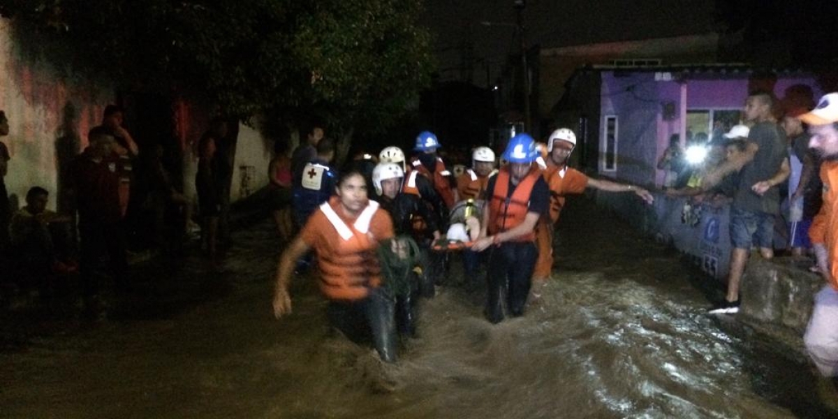 Momento en que autoridades rescatan a una persona afectada en Simón Bolívar.