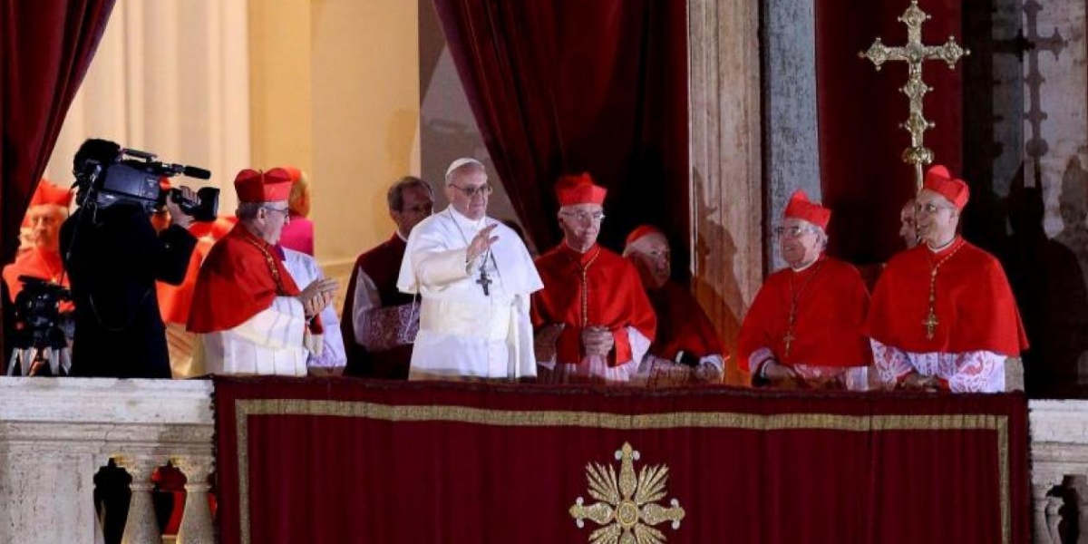 El cardenal argentino Jorge Mario Bergoglio (c) saluda desde el balcón tras ser elegido Papa en la plaza de San Pedro de la ciudad del Vaticano el 13 de marzo de 2013.