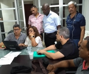 Trabajadores de la universidad firmando el acta.